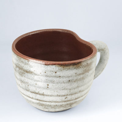 Handcrafted grey ceramic mug with speckles, shaped like an apple